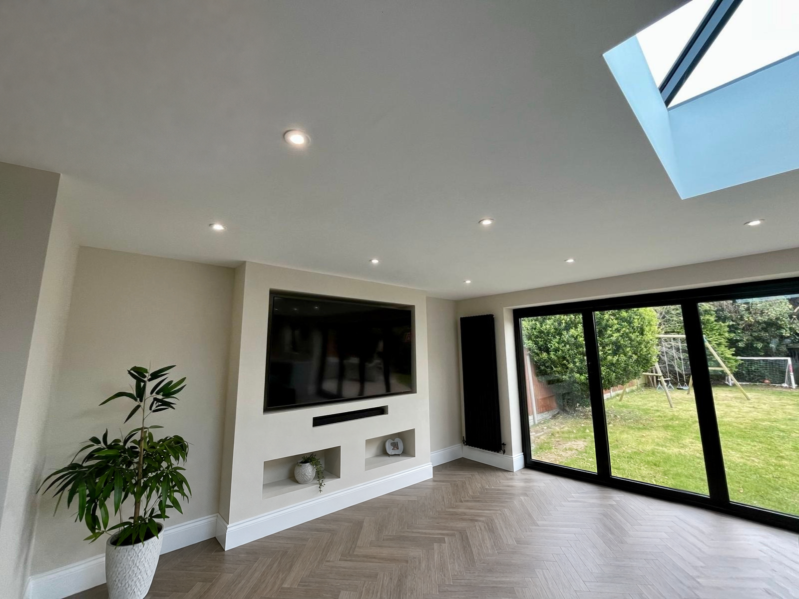 Extended living room with skylight and sliding doors